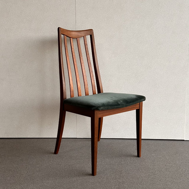 Mid-century British G-PLAN dining chair with vintage teak frame and dark upholstered seat, vertical slat backrest, tapered.
