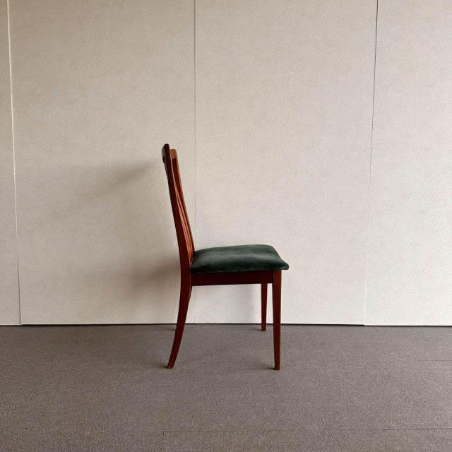 Mid-century British G-PLAN dining chair with teak frame and dark green upholstered vintage seat, showcasing clean lines and.