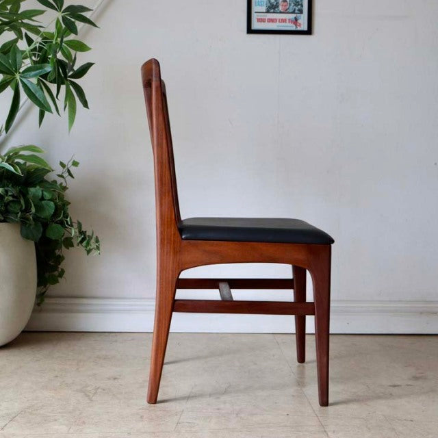 Mid-century vintage teak dining chair by Younger, British design with sleek tapered legs and black cushioned seat.