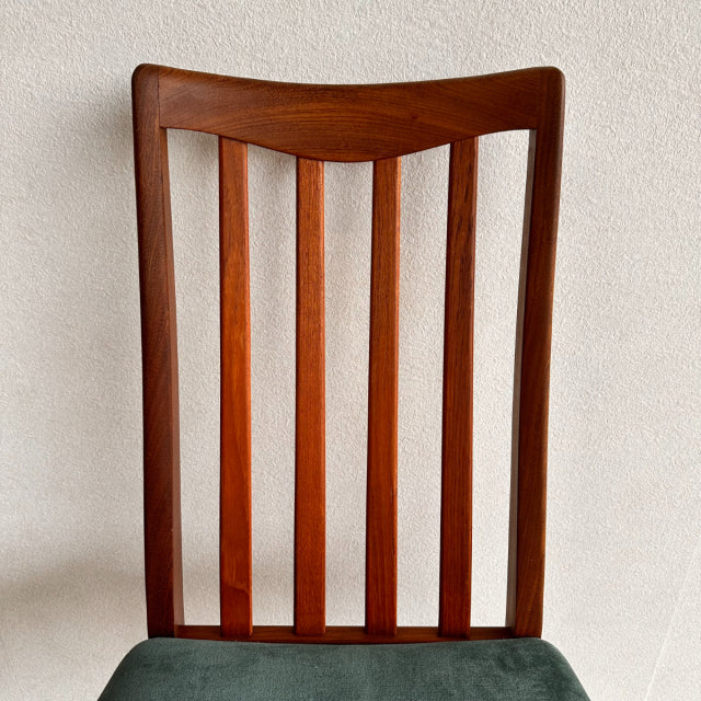 Mid-century British G-Plan dining chair with vintage teak frame, vertical slat back, and warm wood grain finish.