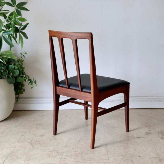 Vintage mid-century British teak dining chair by Younger with slender vertical back slats and black cushioned seat,.