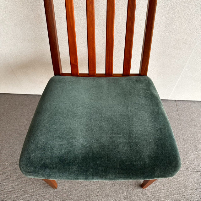 Mid-century British G-PLAN chair with vintage teak frame and dark green velvet cushioned seat, vertical slat backrest,.