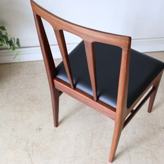 Vintage mid-century teak dining chair by Younger featuring sleek British design with clean wood grain, tapered legs, and.
