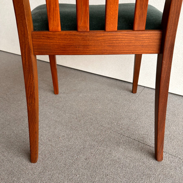 Mid-century British G-PLAN dining chair with teak frame, visible wood grain, vertical slats, and dark upholstered seat.