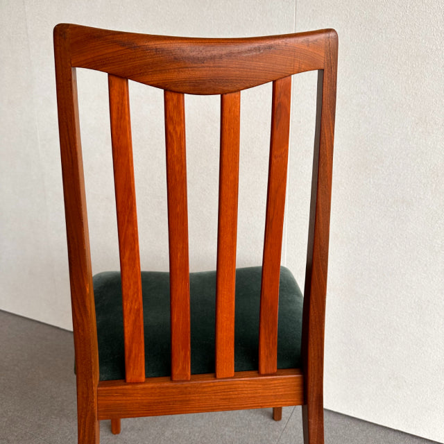 Mid-century British G-PLAN dining chair with teak wood frame, vertical slat backrest, and dark green upholstered seat.