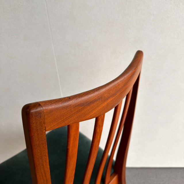 Vintage British G-Plan mid-century teak chair with curved slatted backrest and dark upholstered seat.