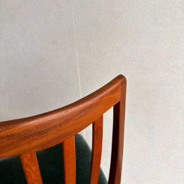 Mid-century British G-PLAN chair with vintage teak frame, curved top rail, and smooth wood grain detailing.
