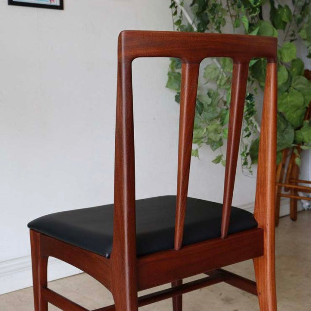 Vintage teak dining chair by Younger with British mid-century design, sleek tapered legs, and black upholstered seat.