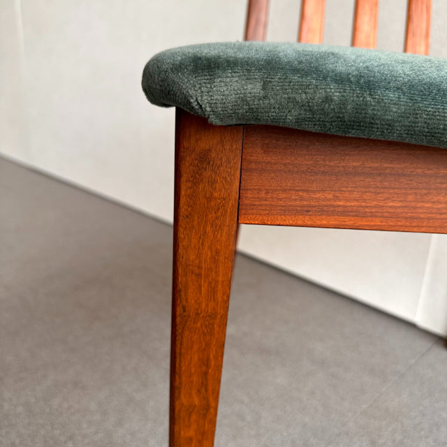 Mid-century British G-PLAN chair with teak frame, visible wood grain, and green fabric seat upholstery.