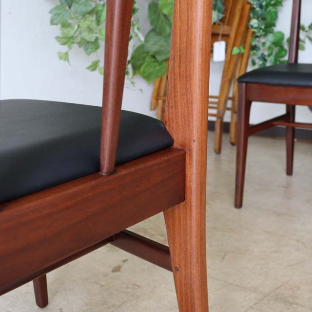Vintage teak dining chair by Younger with sleek British mid-century design, smooth wood grain, and black leather seat cushion.