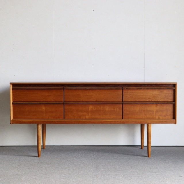 Mid-century British vintage teak sideboard by Austinsuite with six drawers, sleek wood grain, and tapered legs from Denmark.