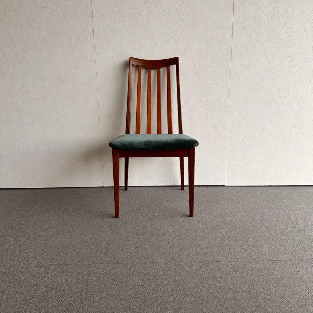 Mid-century British G-PLAN dining chair with teak wood frame, vertical slat backrest, and dark upholstered seat.