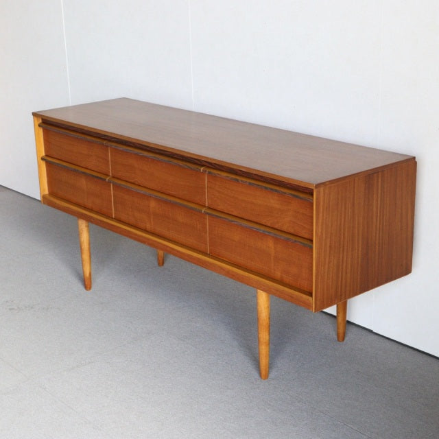 Mid-century British vintage teak sideboard by Austinsuite with rich wood grain, six drawers, and tapered legs from Denmark.