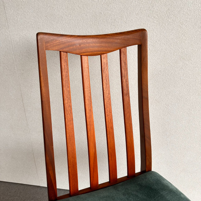 Mid-century British vintage G-Plan dining chair with teak wood frame and vertical slat backrest, dark green upholstered seat.