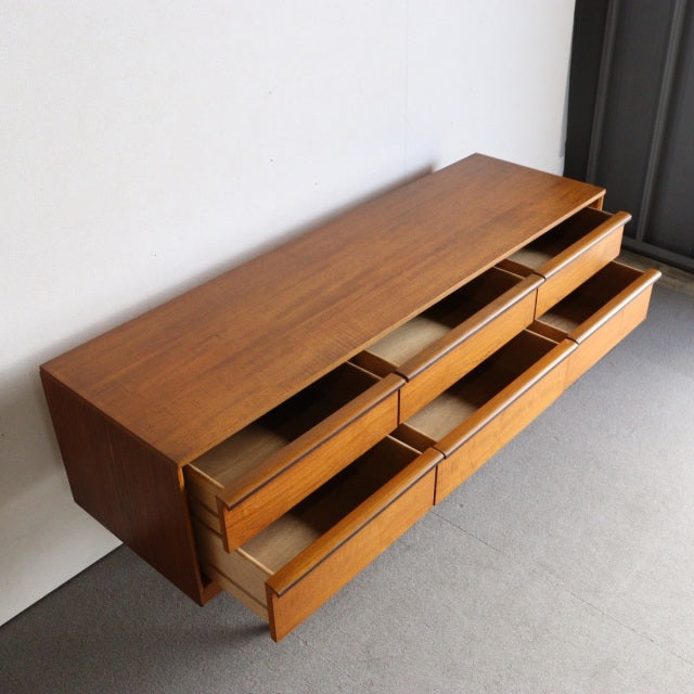 Vintage teak mid-century sideboard by Austinsuite, British design with rich wood grain, clean lines, and tapered legs, five.