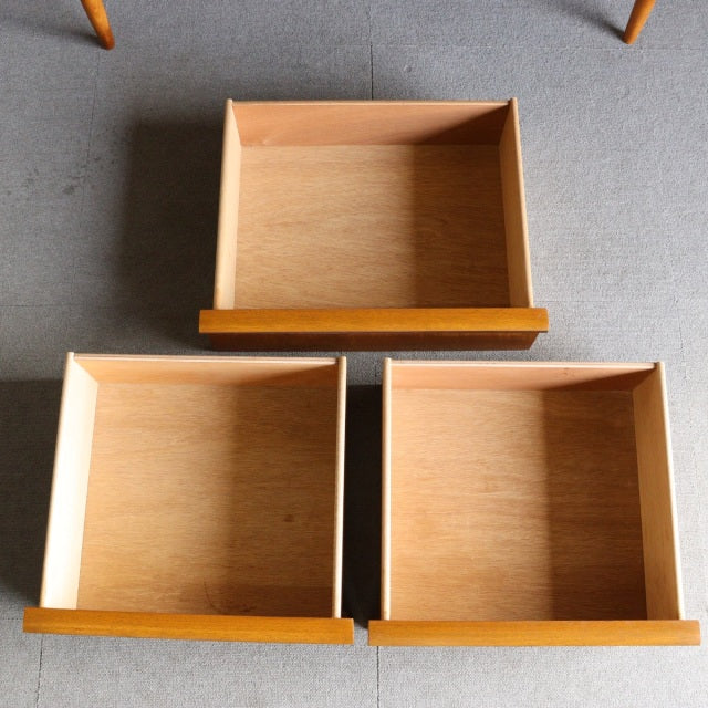 Three open teak drawers with visible wood grain and clean mid-century lines from Austinsuite British vintage sideboard.
