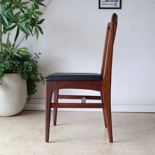 Mid-century vintage teak dining chair by Younger, British design with sleek wood grain and black upholstered seat, slender.