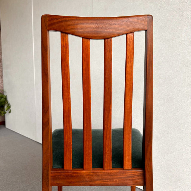 Mid-century British vintage teak dining chair by G-PLAN with vertical slat back and dark upholstered seat.