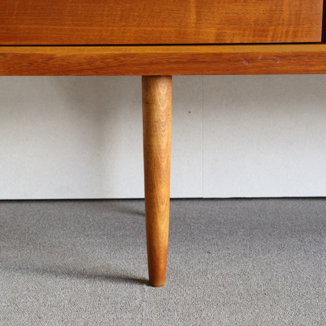 Mid-century British vintage teak sideboard leg with tapered cylindrical design and smooth wood grain finish.