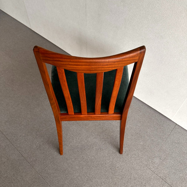 Mid-century British G-Plan dining chair with vintage teak frame and black upholstered backrest, visible wood grain on curved .