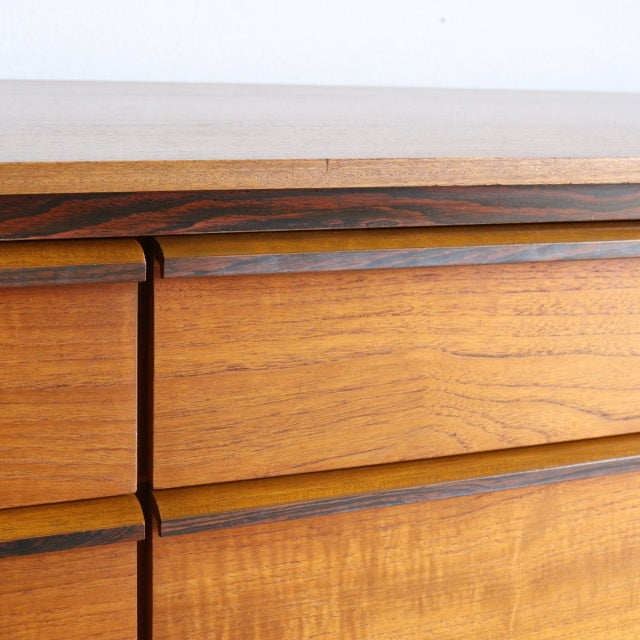 Vintage mid-century Austinsuite teak sideboard drawer close-up showing rich wood grain and smooth rounded edges.