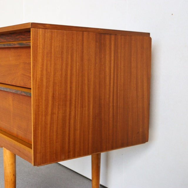 Mid-century British vintage teak sideboard by Austinsuite with visible wood grain and tapered legs.