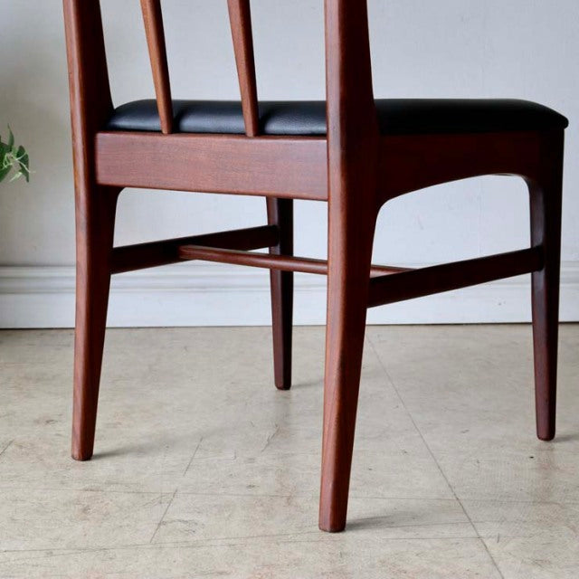 Set of four vintage mid-century British dining chairs by A.Younger Ltd., crafted from rich teak wood with sleek tapered legs .
