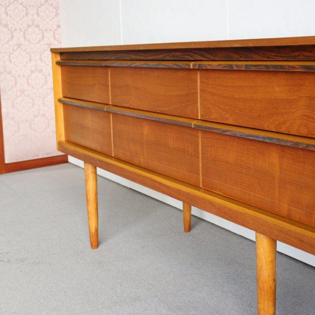 Vintage mid-century Austinsuite teak sideboard with rich wood grain, slender tapered legs, and clean British-Denmark design.