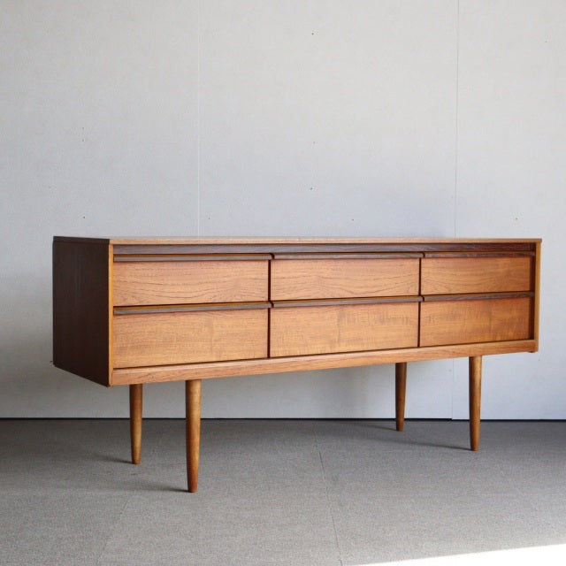 Mid-century British vintage teak sideboard by Austinsuite with smooth wood grain and slender tapered legs.