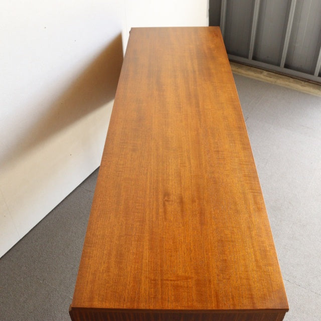 Vintage mid-century Austinsuite teak sideboard from Britain, showcasing rich wood grain and sleek, tapered legs with a.