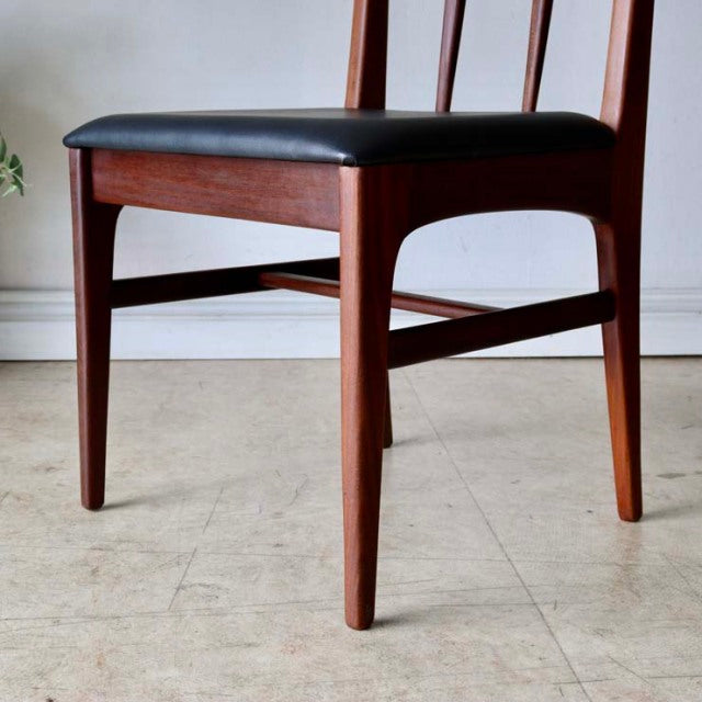 Set of four British mid-century dining chairs by A.Younger Ltd., crafted from rich teak wood with visible grain, featuring.