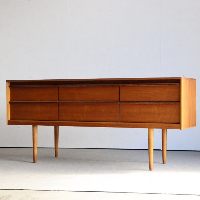 Mid-century British vintage teak sideboard by Austinsuite with smooth wood grain, clean lines, and tapered legs from Denmark .