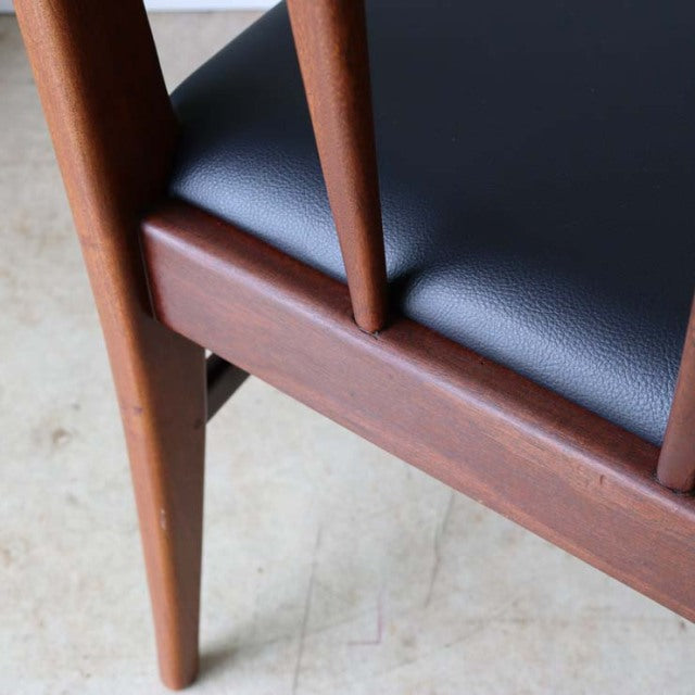 Vintage mid-century teak dining chair leg and frame with smooth grain and black leather seat upholstery, British-Denmark.
