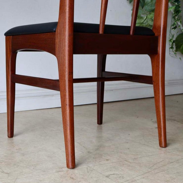 Vintage mid-century teak dining chair with sleek tapered legs and black upholstered seat, British-Denmark style.