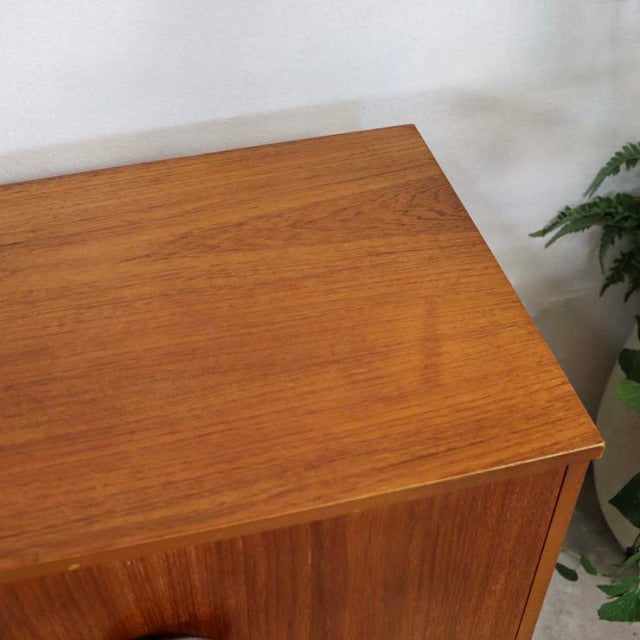 Mid-century British vintage teak sideboard with smooth wood grain and minimalist lines, Danish-inspired design.