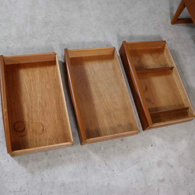 Set of three vintage teak trays with distinct mid-century British and Danish design, featuring smooth wood grain and raised.