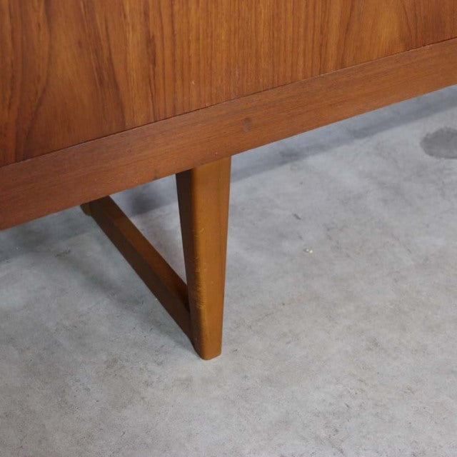 Mid-century British vintage teak sideboard leg with distinctive angled design and rich wood grain detail.