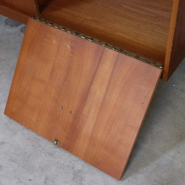 Mid-century British vintage teak sideboard door with visible wood grain and brass hinge detailing.