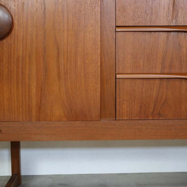 Mid-century British vintage teak sideboard with distinctive wood grain, unique legs, and clean Scandinavian-inspired design.