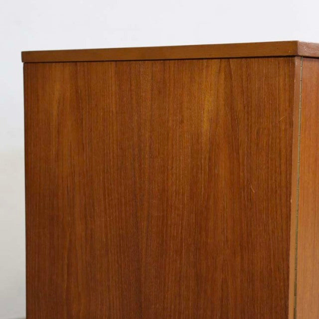 Mid-century British vintage teak sideboard showing rich wood grain and clean-lined rectangular form with unique angled legs.