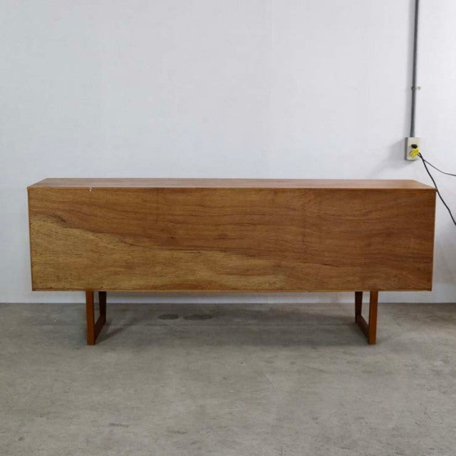 Vintage mid-century British teak sideboard with distinctive angled legs and clean wood grain finish.