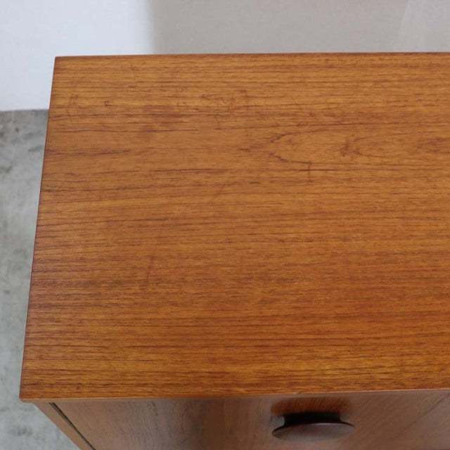 Vintage British teak sideboard top showing rich mid-century wood grain with smooth finish and warm tones.