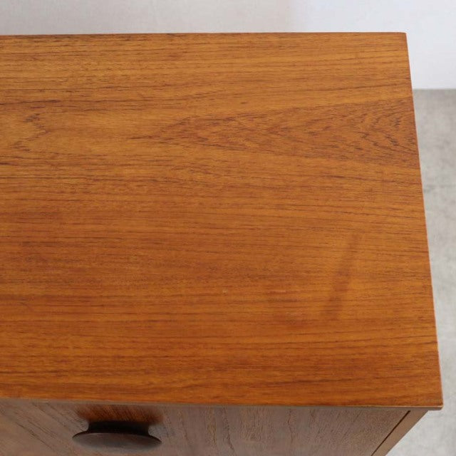 Vintage teak British mid-century sideboard top showing smooth wood grain and warm honey tones.