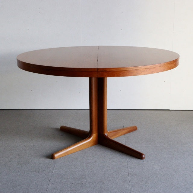 Round mid-century teak dining table by Edward Valentinsen with smooth wood grain and British-Denmark vintage style legs.