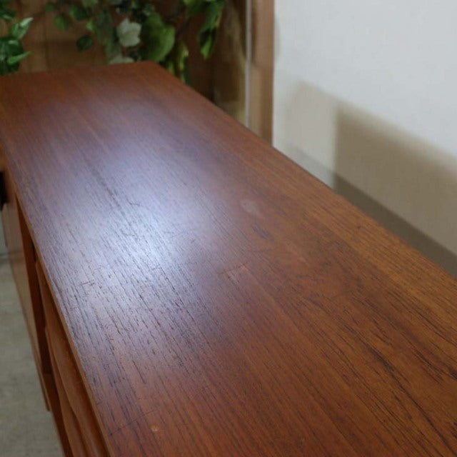 Long vintage teak sideboard top showing rich wood grain and smooth mid-century British craftsmanship.