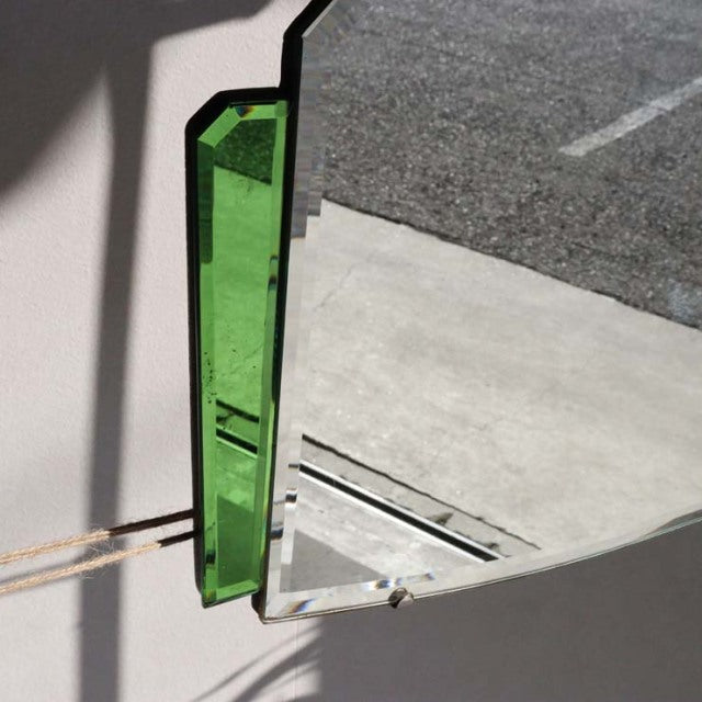 Vintage British mid-century teak wall mirror with green tinted edges and angular frame detail.