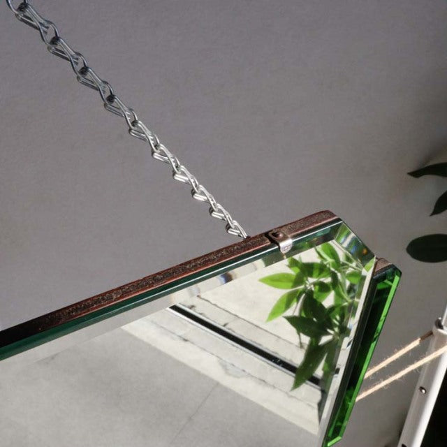 Vintage mid-century teak wall mirror with green beveled glass edges, British and Danish design influence, hanging by a metal .