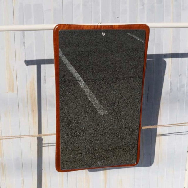Mid-century British vintage wall mirror with rounded corners, teak wood frame showcasing rich grain and warm tones.