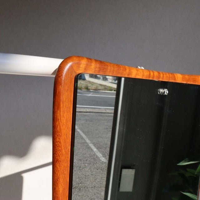 Mid-century British vintage teak wall mirror with rounded corners and warm wood grain finish.