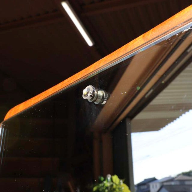 Mid-century British vintage teak wall mirror with rounded corners and visible rich wood grain.